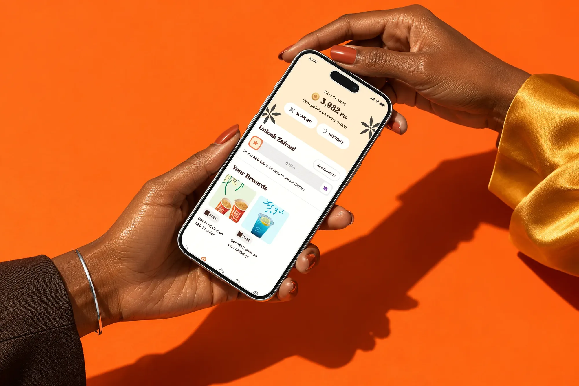 FiLLi Orange tier rewards screen on a phone held in two hands